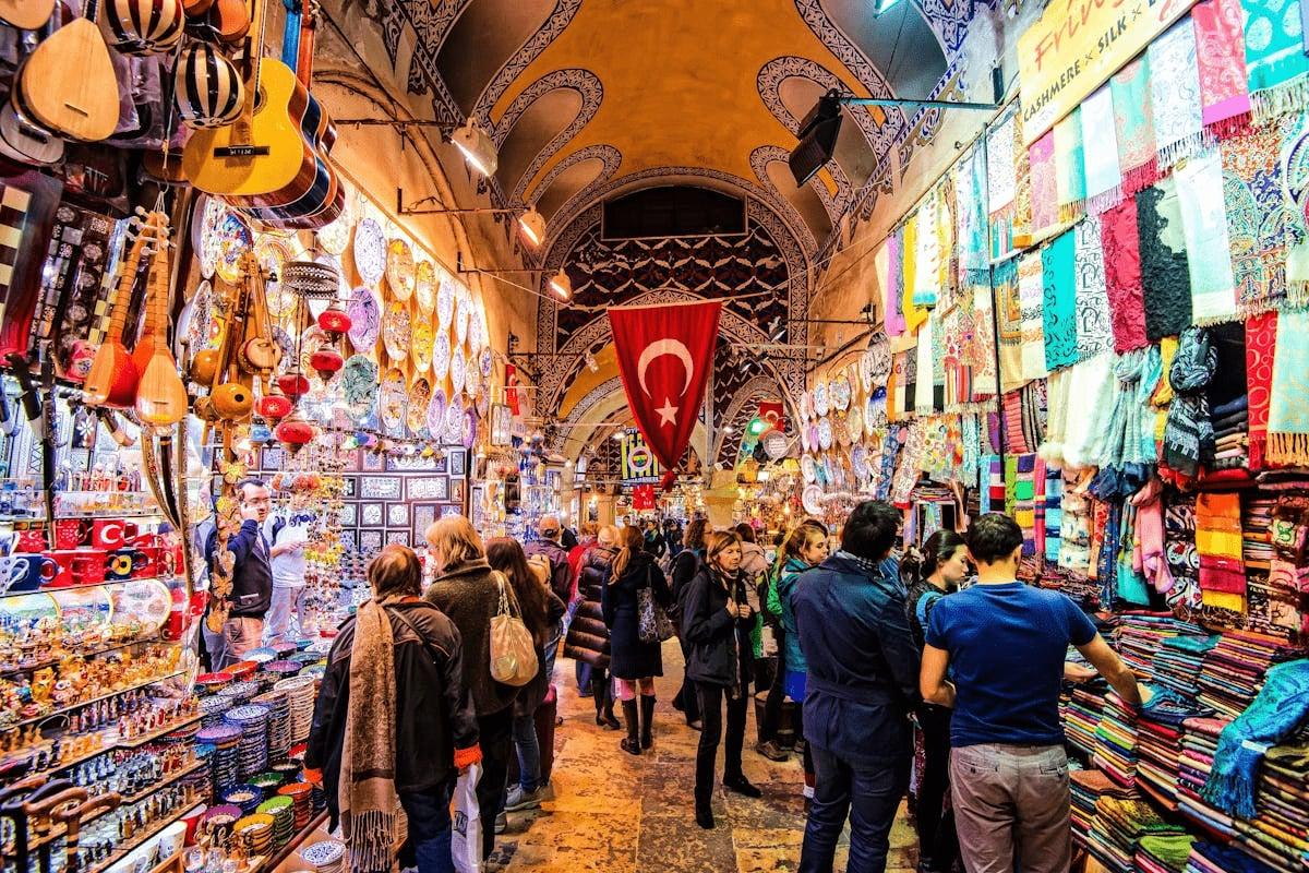 Shoppers between instrument and textile stalls in Istanbul's covered Grand Bazaar